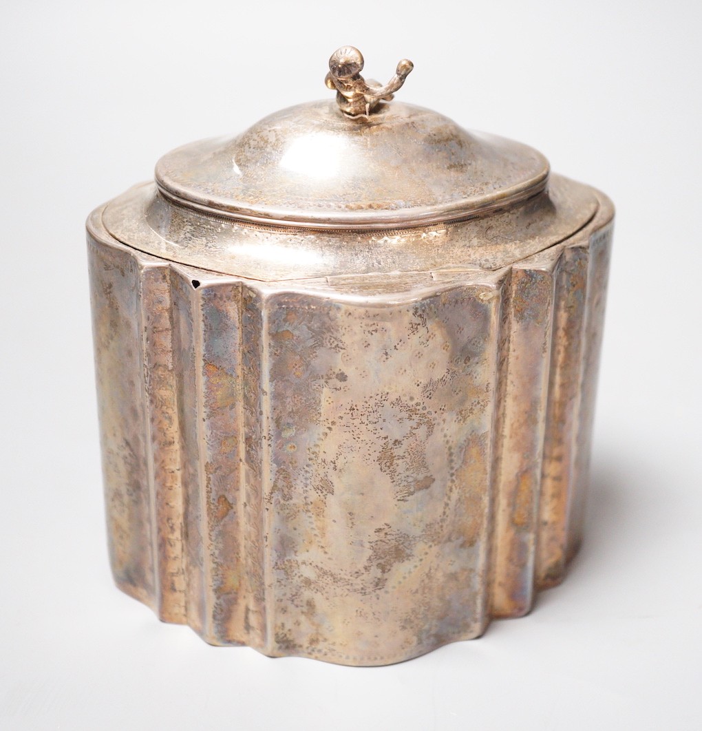 A George III engraved silver shaped oval tea caddy, the finial modelled as a seated oriental figure, Robert Hennell I, London, 1789, height 15cm, 12.5oz (a.f.), no key.